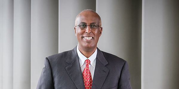 Smiling man in suit poses for photo
