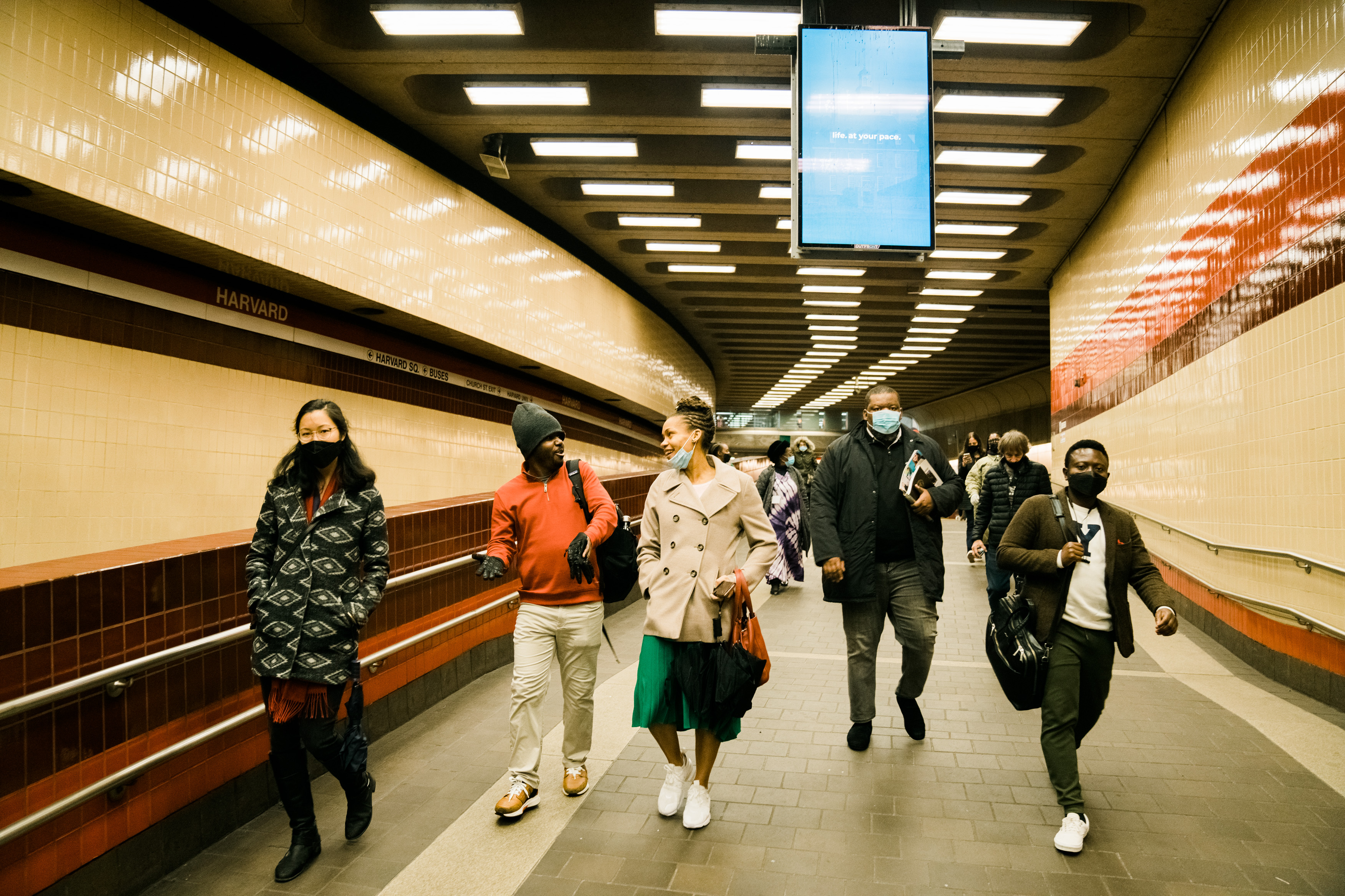 Five people walking through an airport