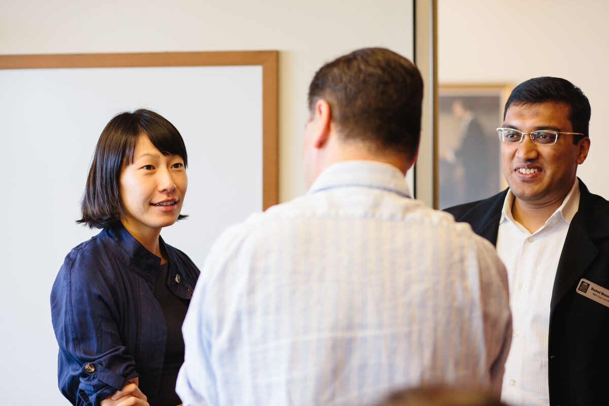 Three MIT students talking in a group