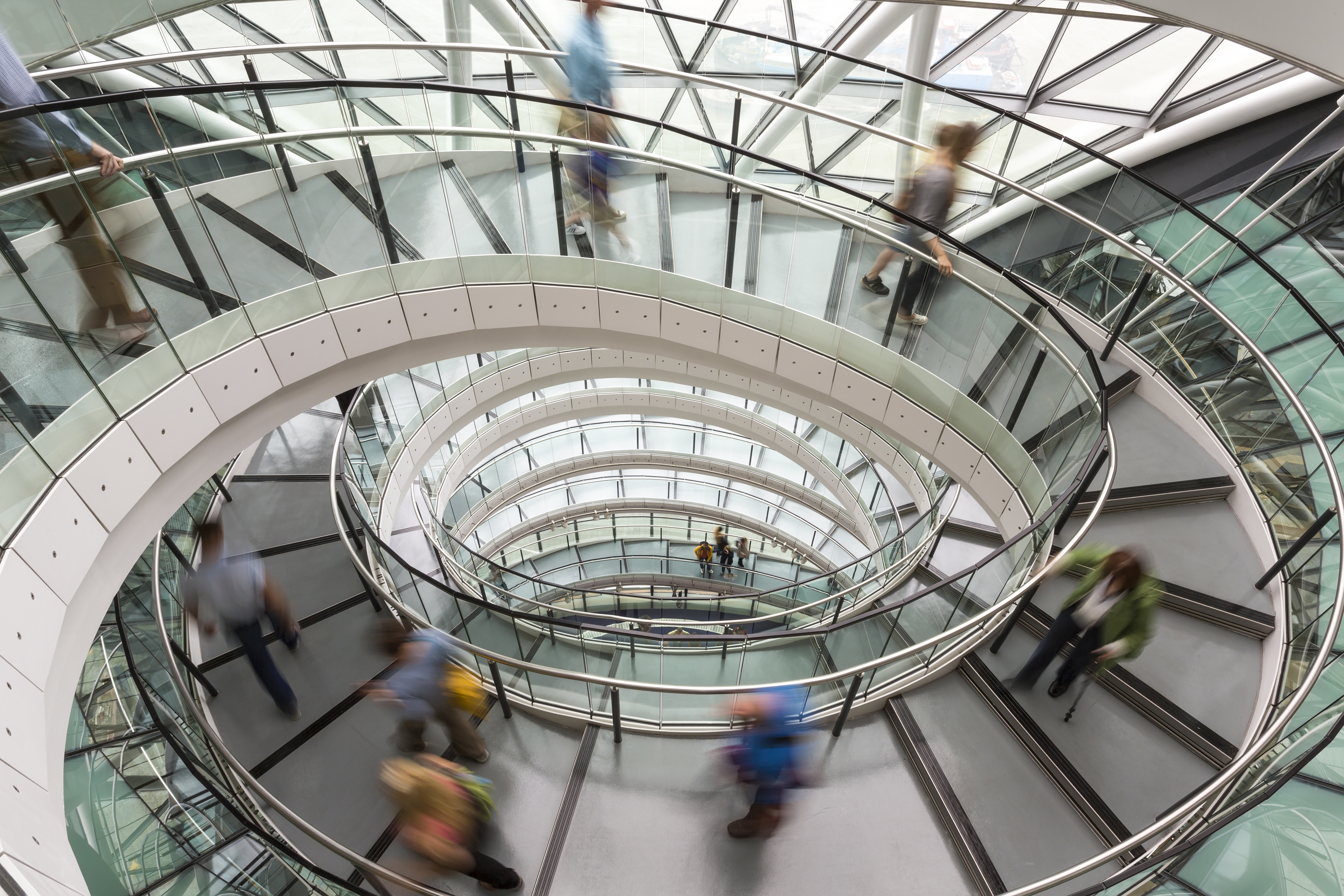 Photograph of a circular staircase and people quickly moving up and down