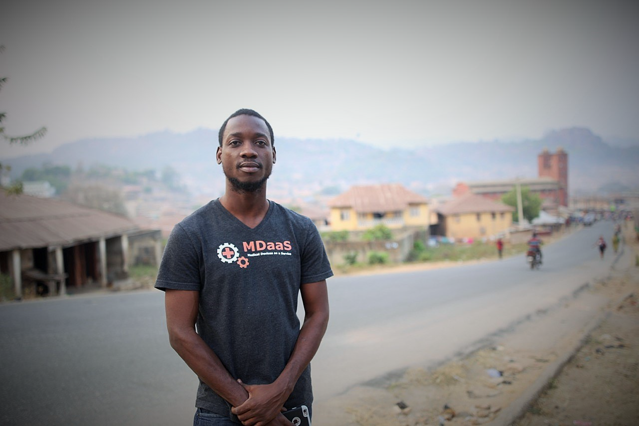 photo of a man standing on a side of road