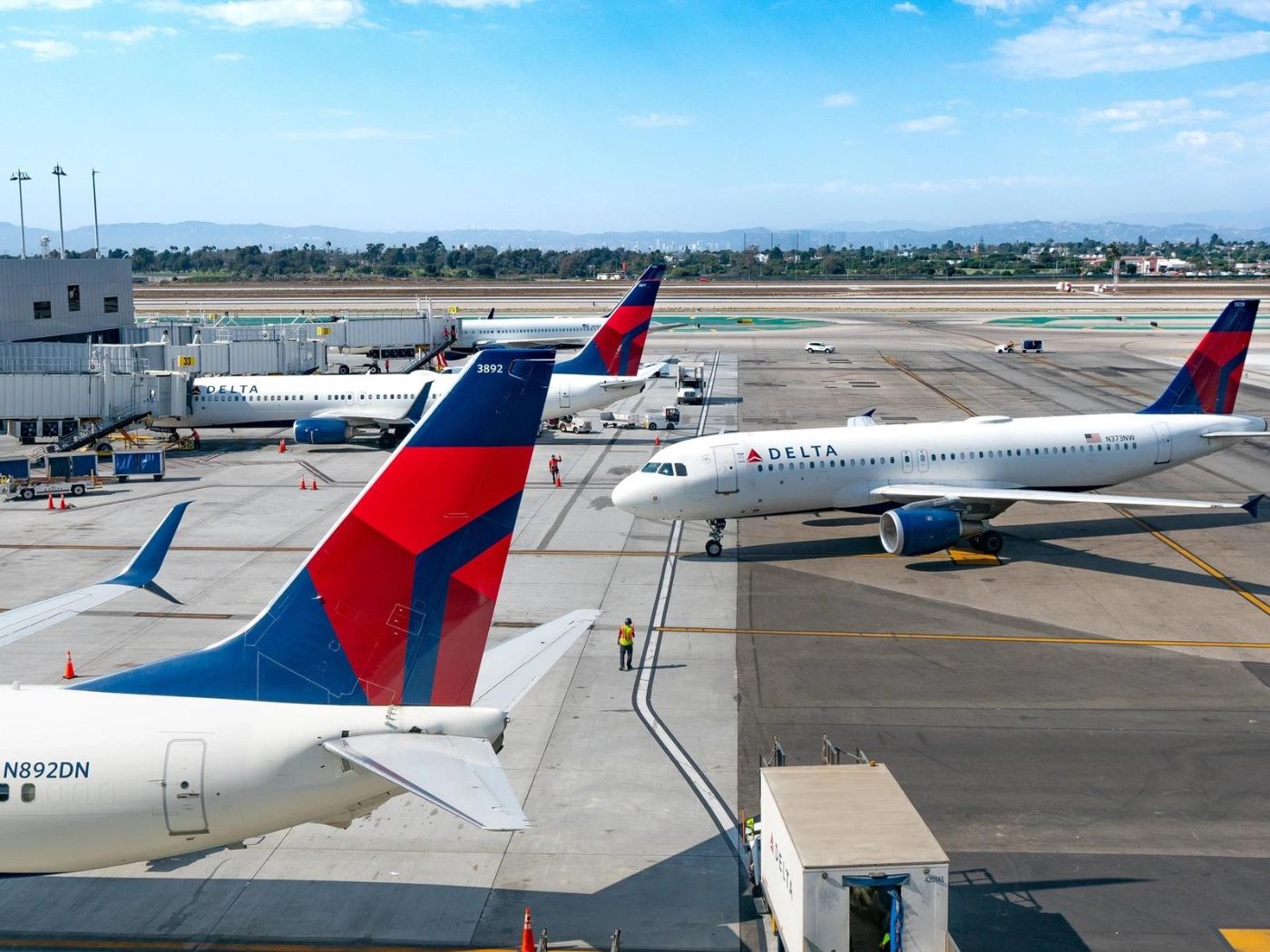 Three delta planes at gate during daytime