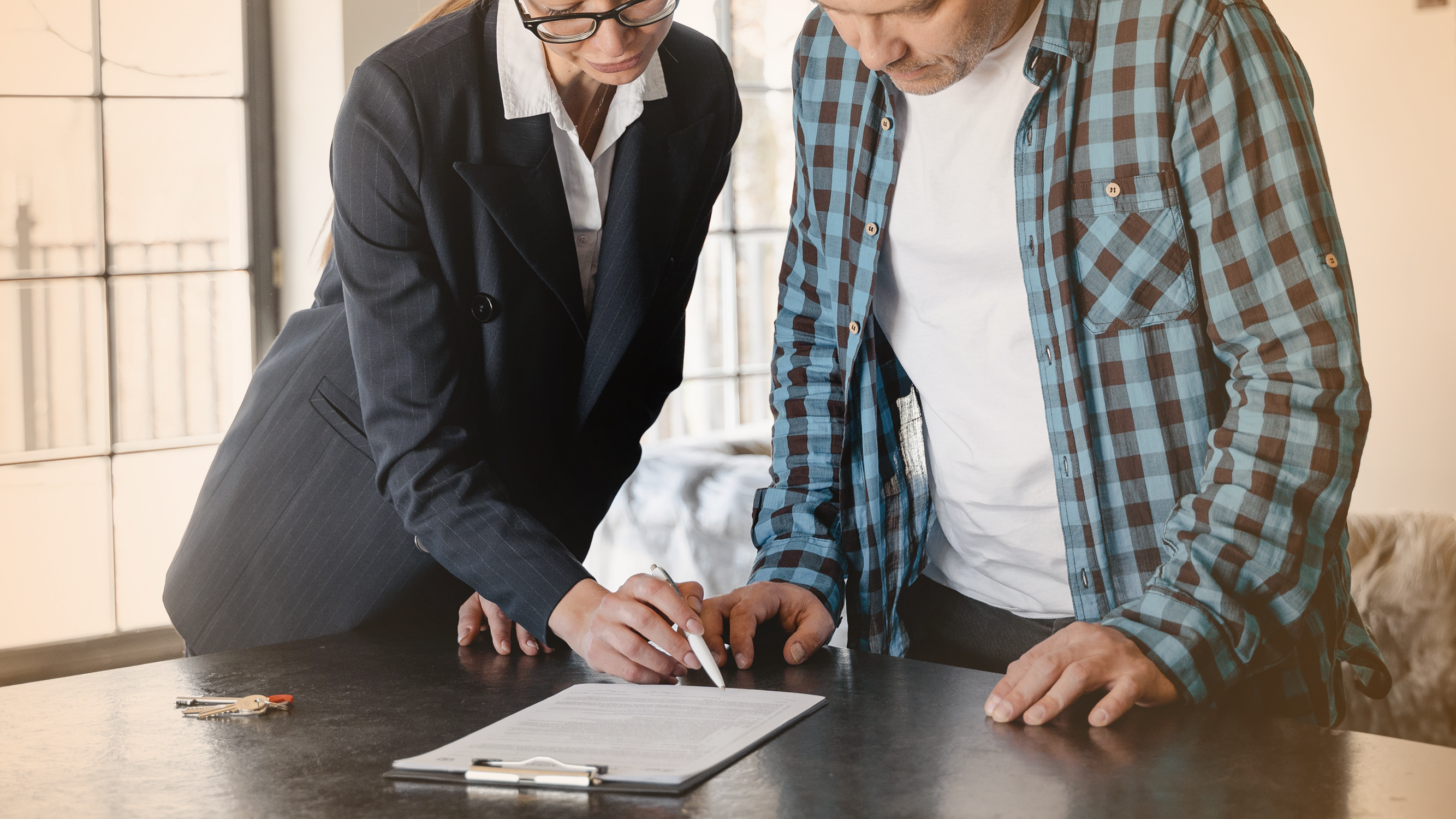 Real estate agent reviewing home loan and mortgage information with home buyer, relating to subprime mortgages