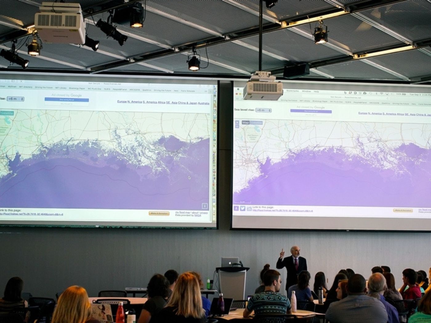 Professor John Sterman displays maps showing the consequences of sea-level rise on various coastal cities, as part of the “SimPlanet” event at MIT.
