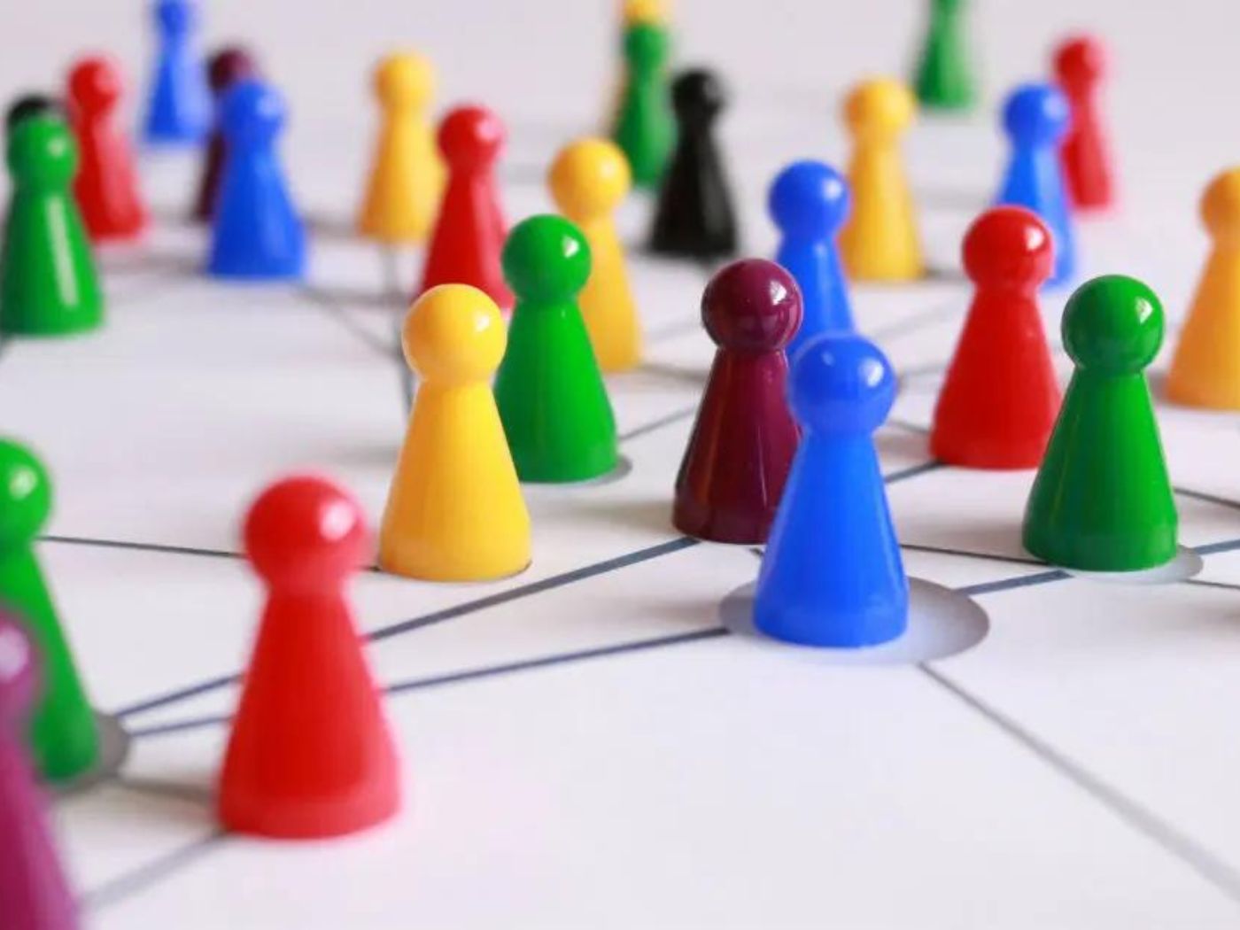 Colorful game board pieces on white game board with black lines