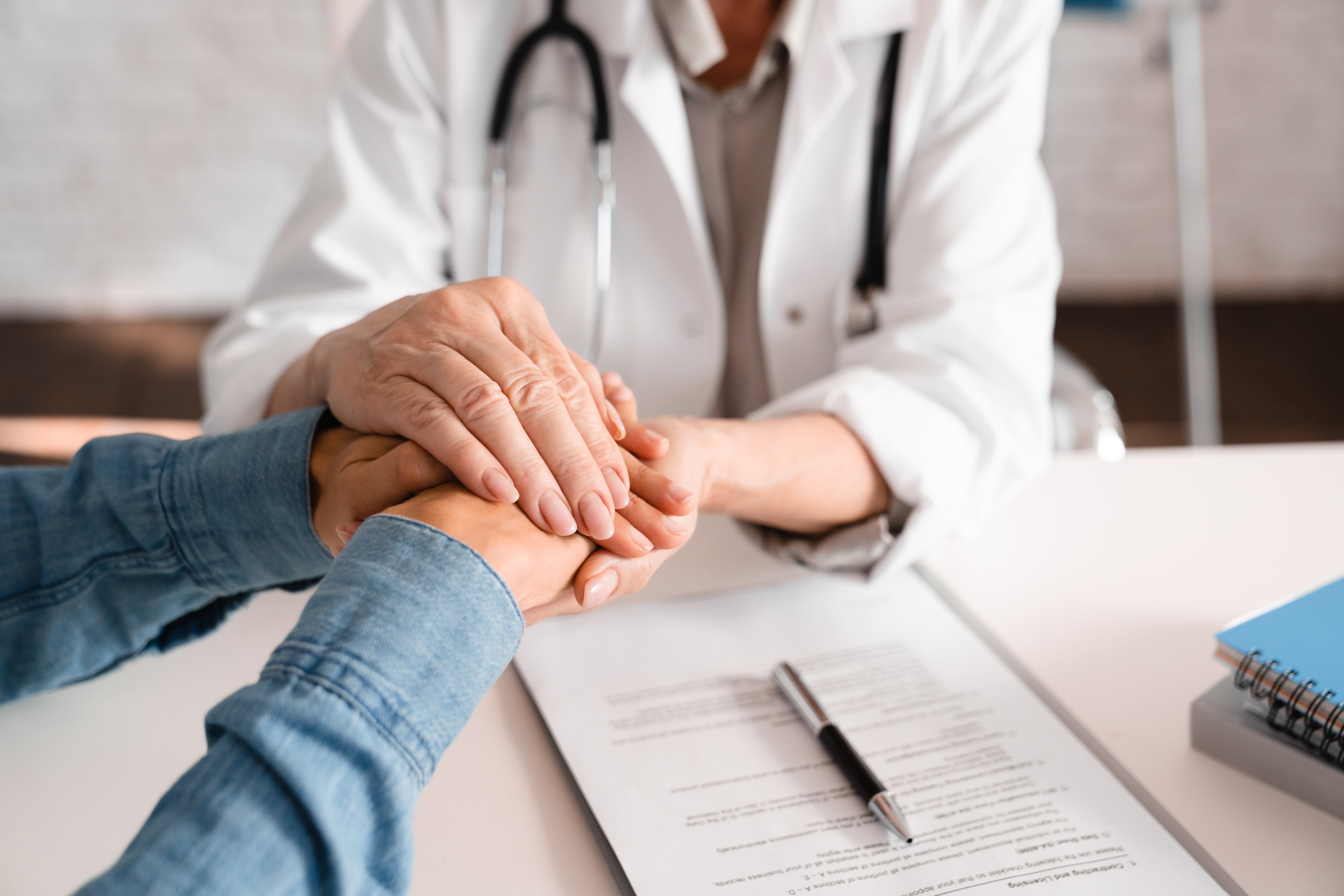 Doctor patient grasping hands