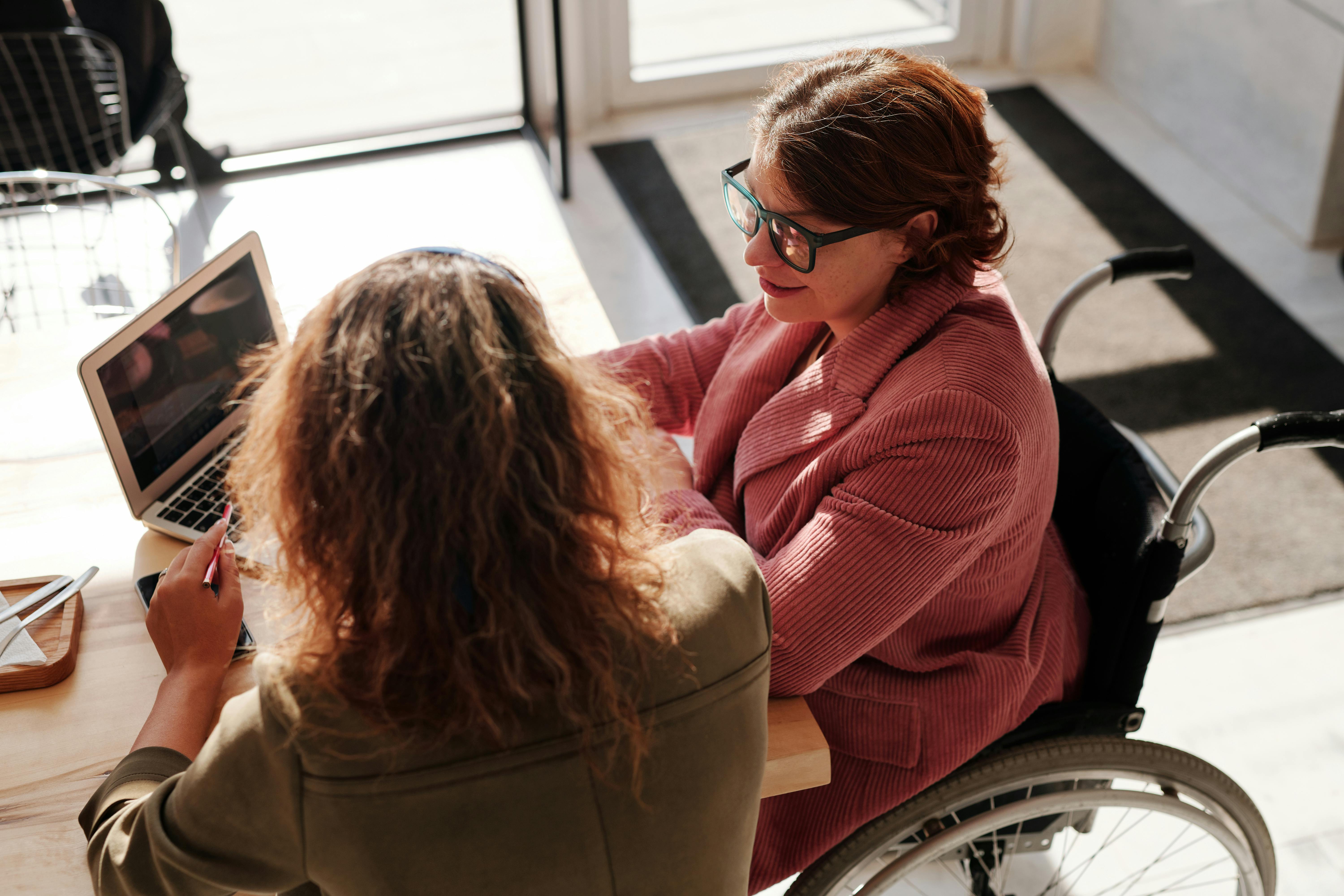 Woman at desk working with a financial advisor on a computer
