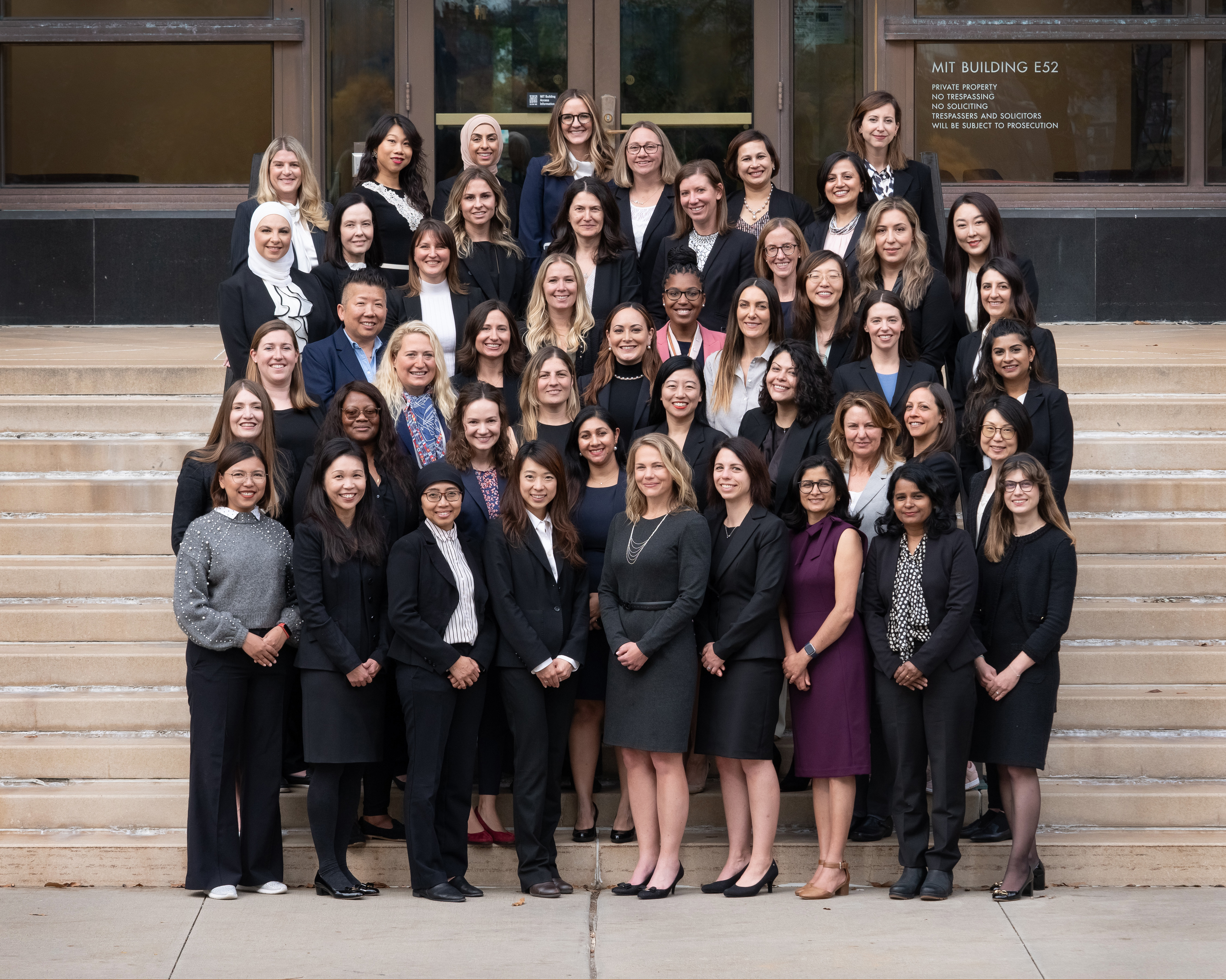 MIT EMBA Class of 2025 women on the steps outside of MIT building E52