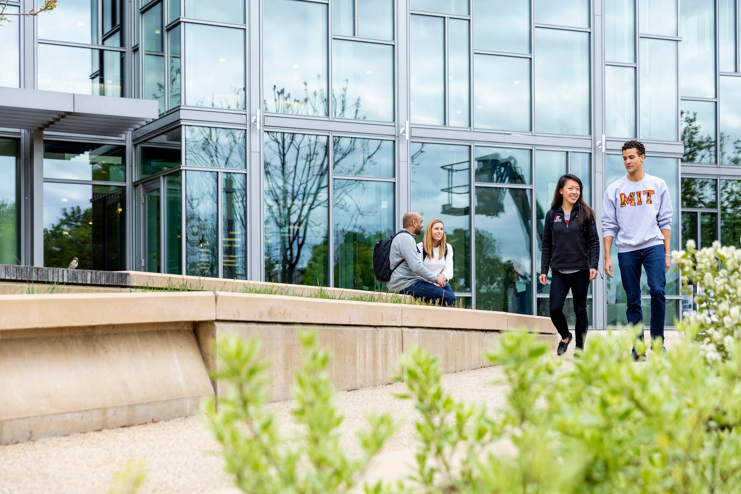 Students walking in front of a building at MIT Sloan