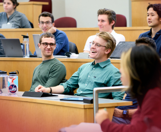 Students in the Masters of Business Analytics program listen in a lecture hall
