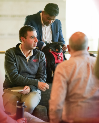 Three executive MBA students gather to converse