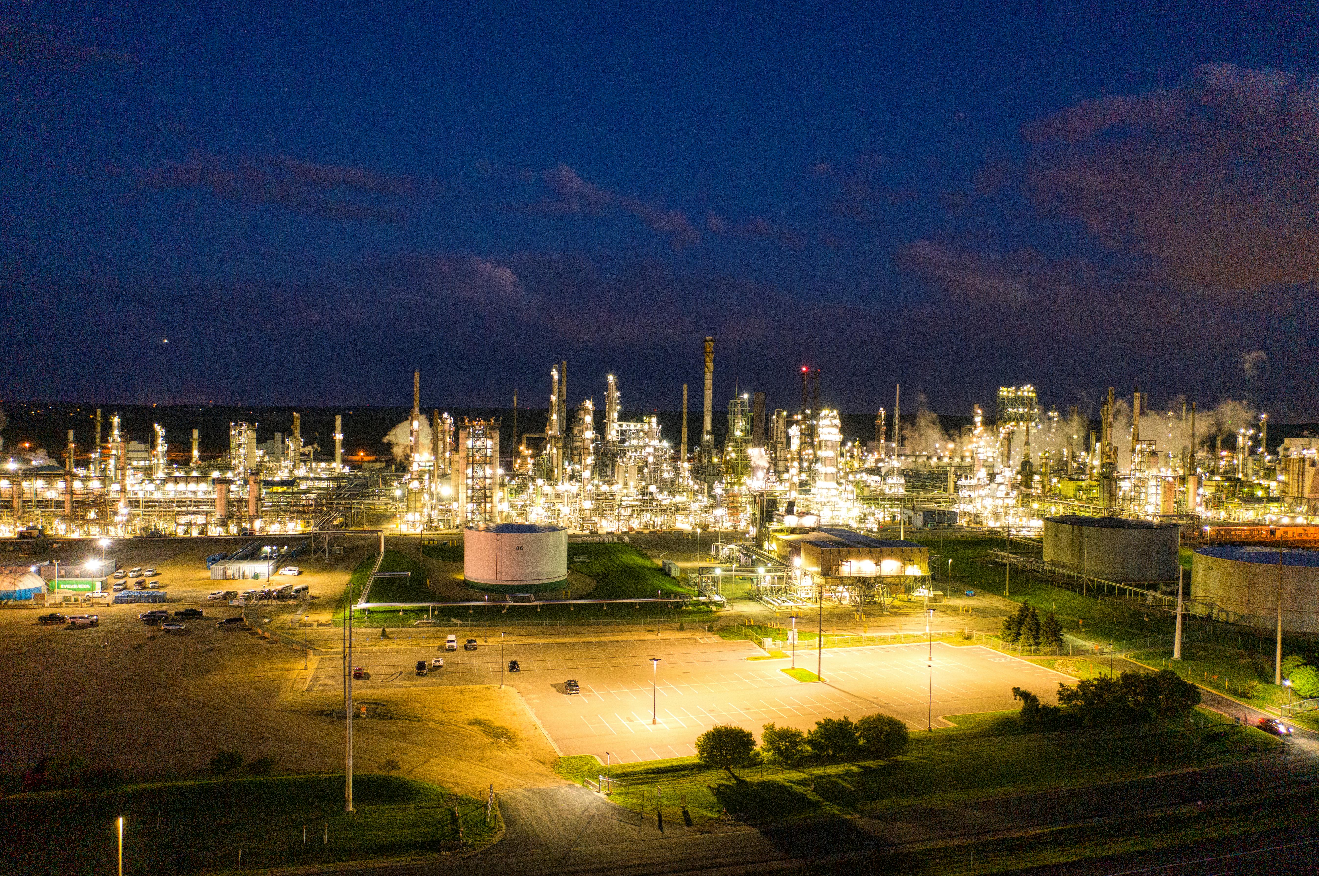 Image of a brightly lit refinery at night