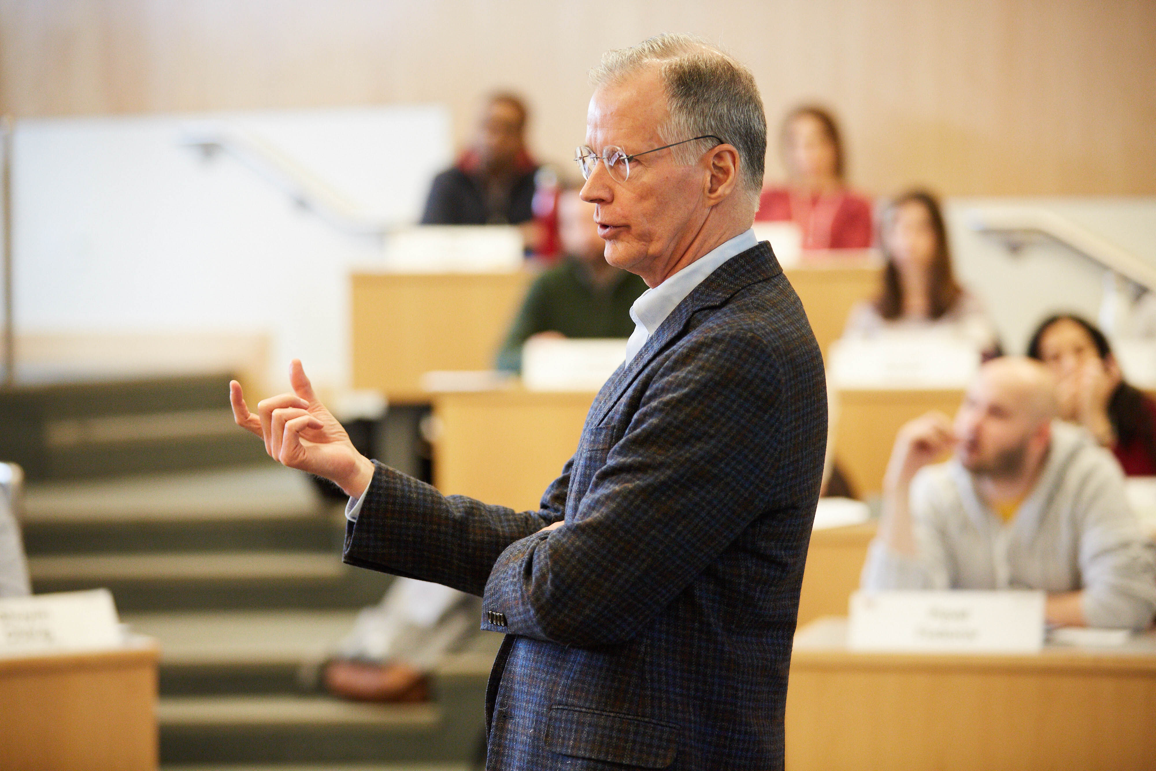 Professor Thomas Malone explaining something at the front of a classroom