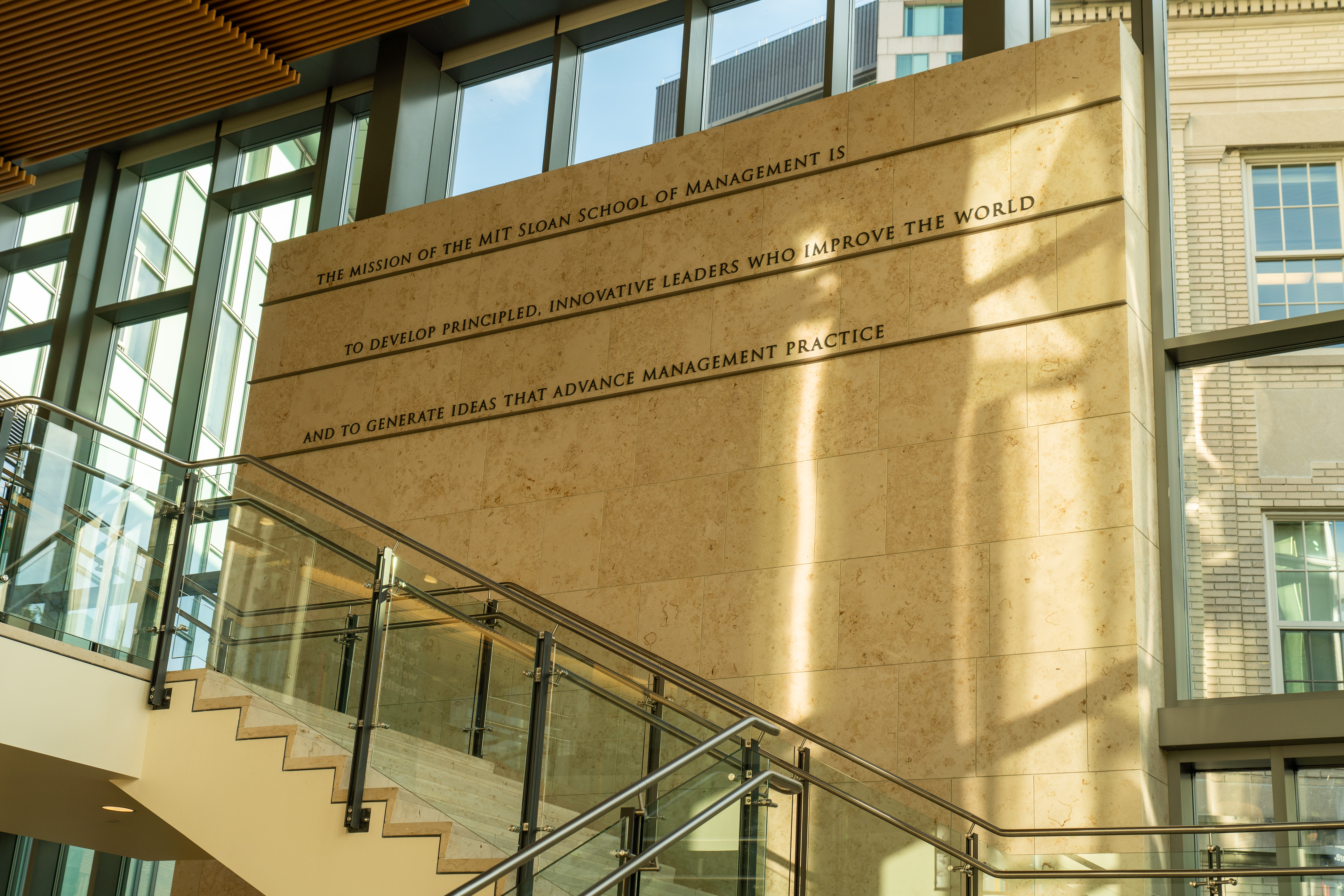Wall with text reading "the mission of the mit sloan school of management is to develop principled, innovative leaders who improve the world and to generate ideas that advance management practice"