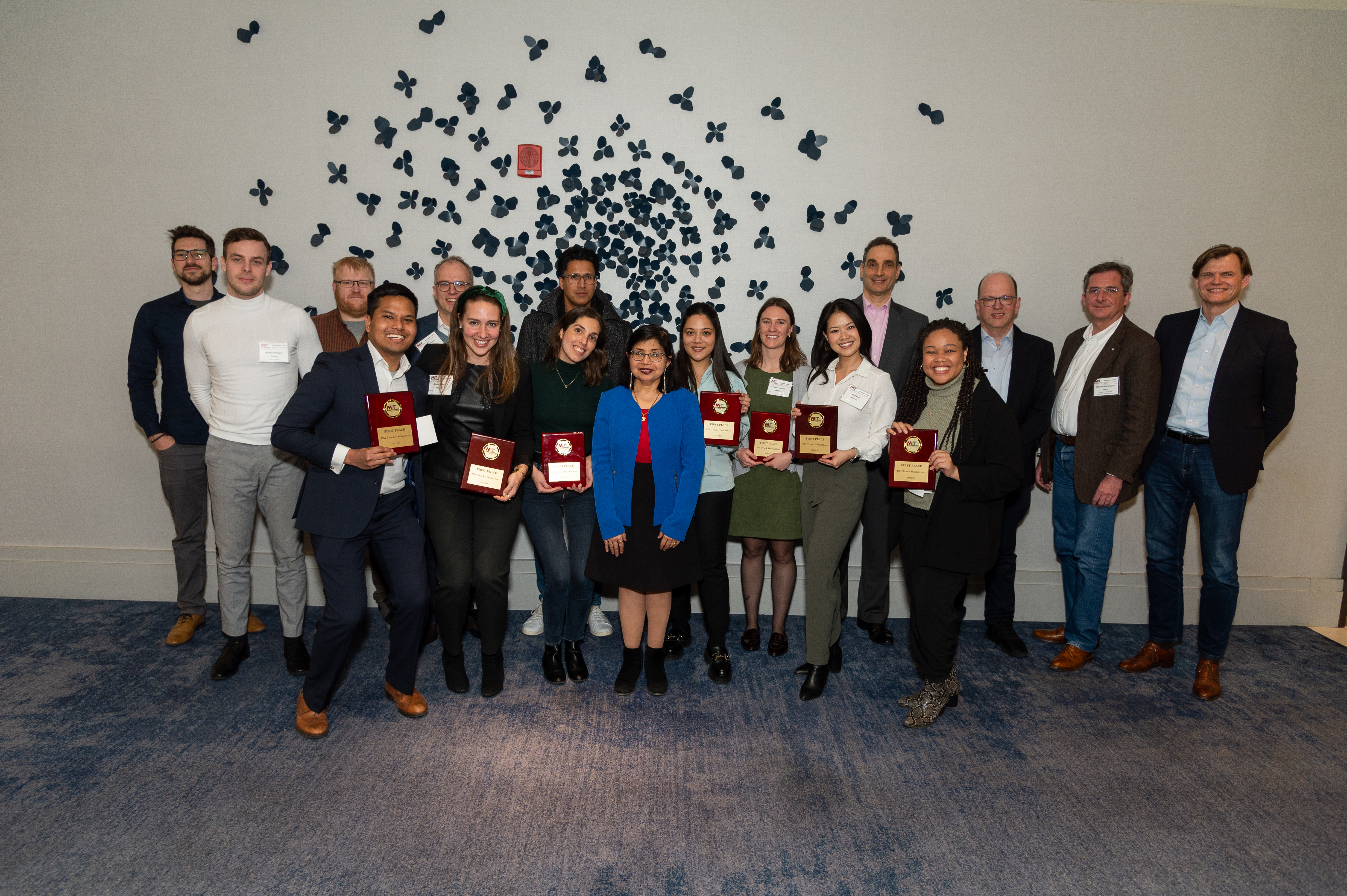 Group photo with Sharmila Chatterjee, the Hackathon 2024 judges, and the winning student team holding their plaques