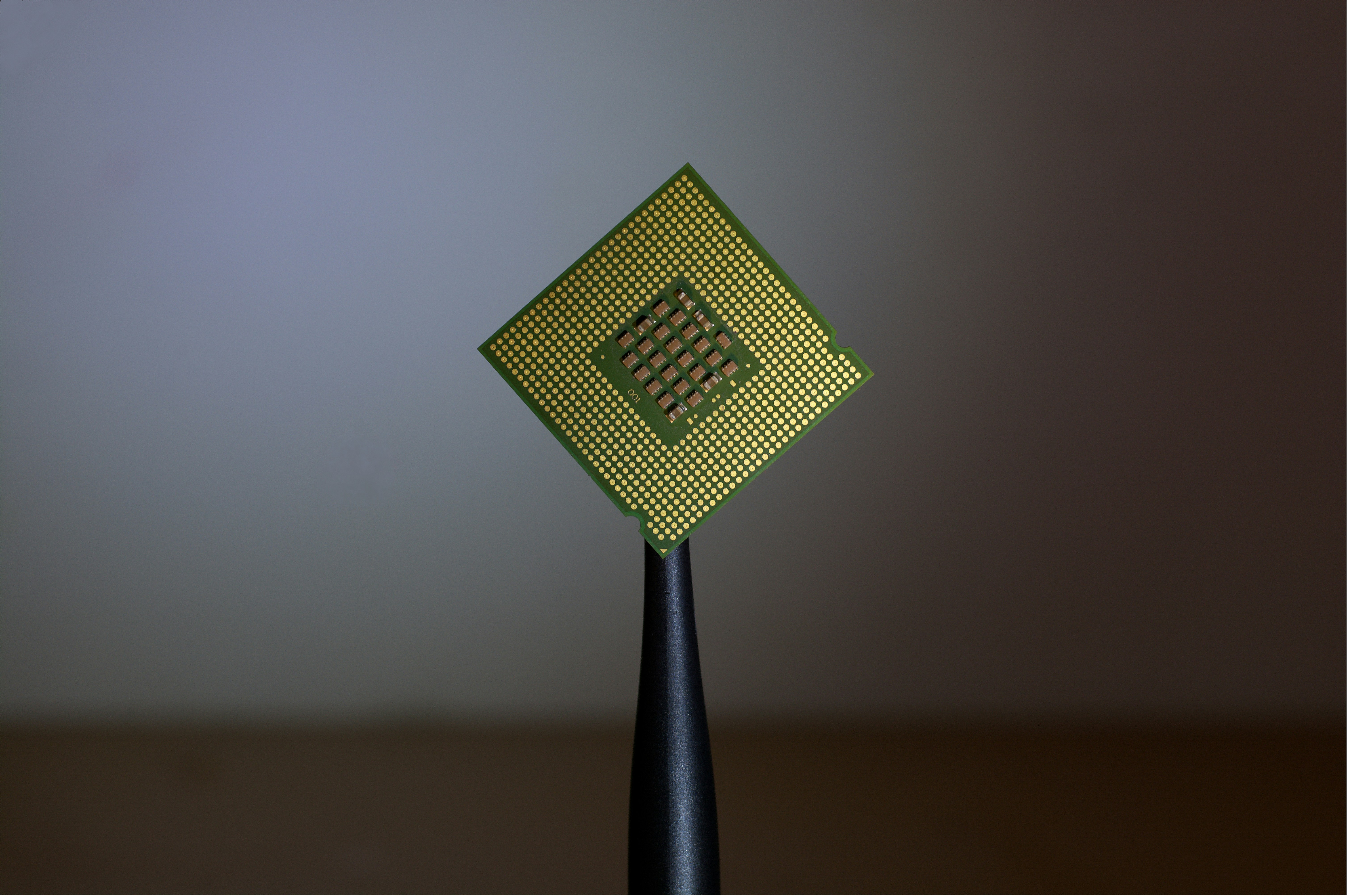 Photo of semiconductor on black stand against dark gray background