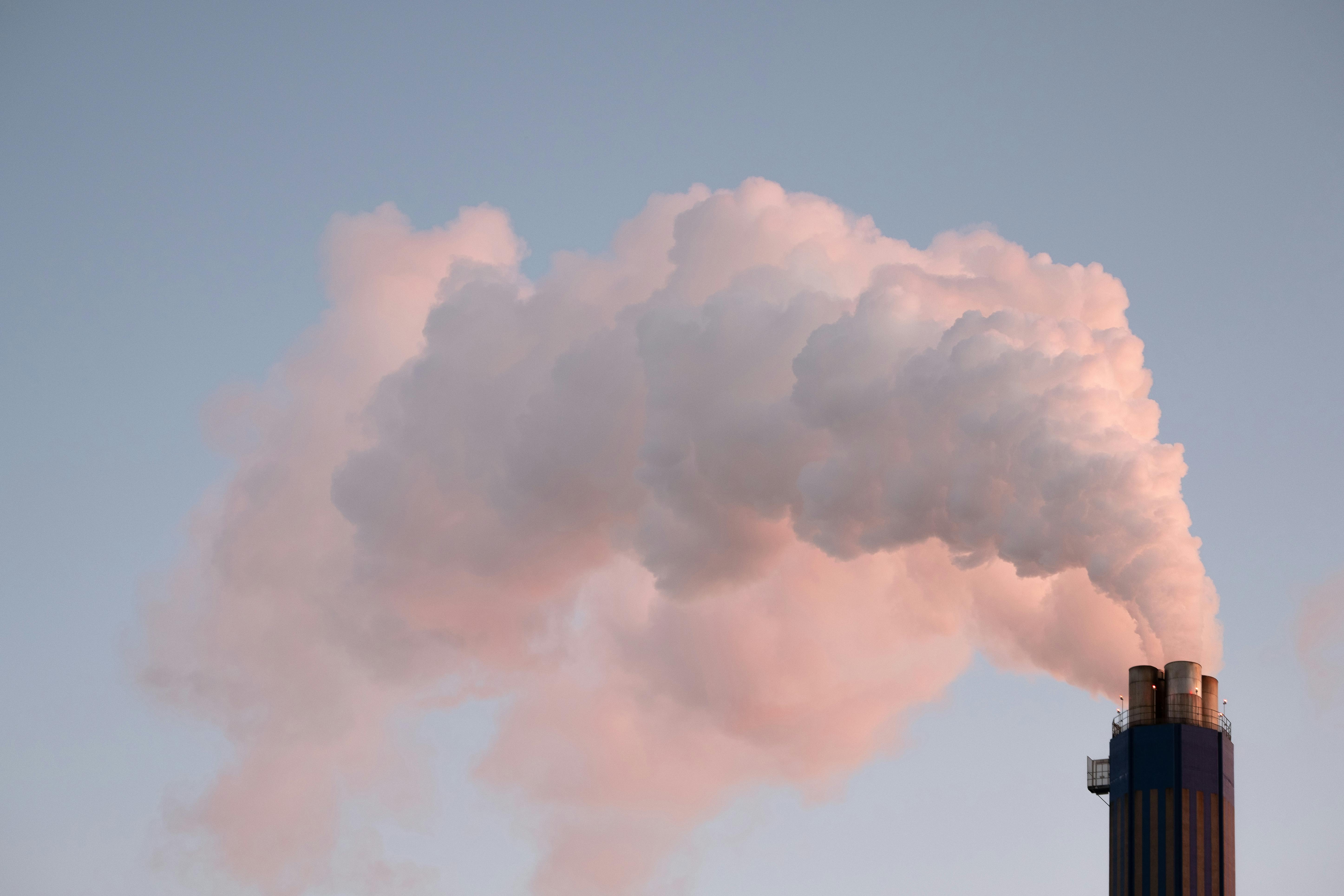 Smoke in the sky exiting a power plant stack