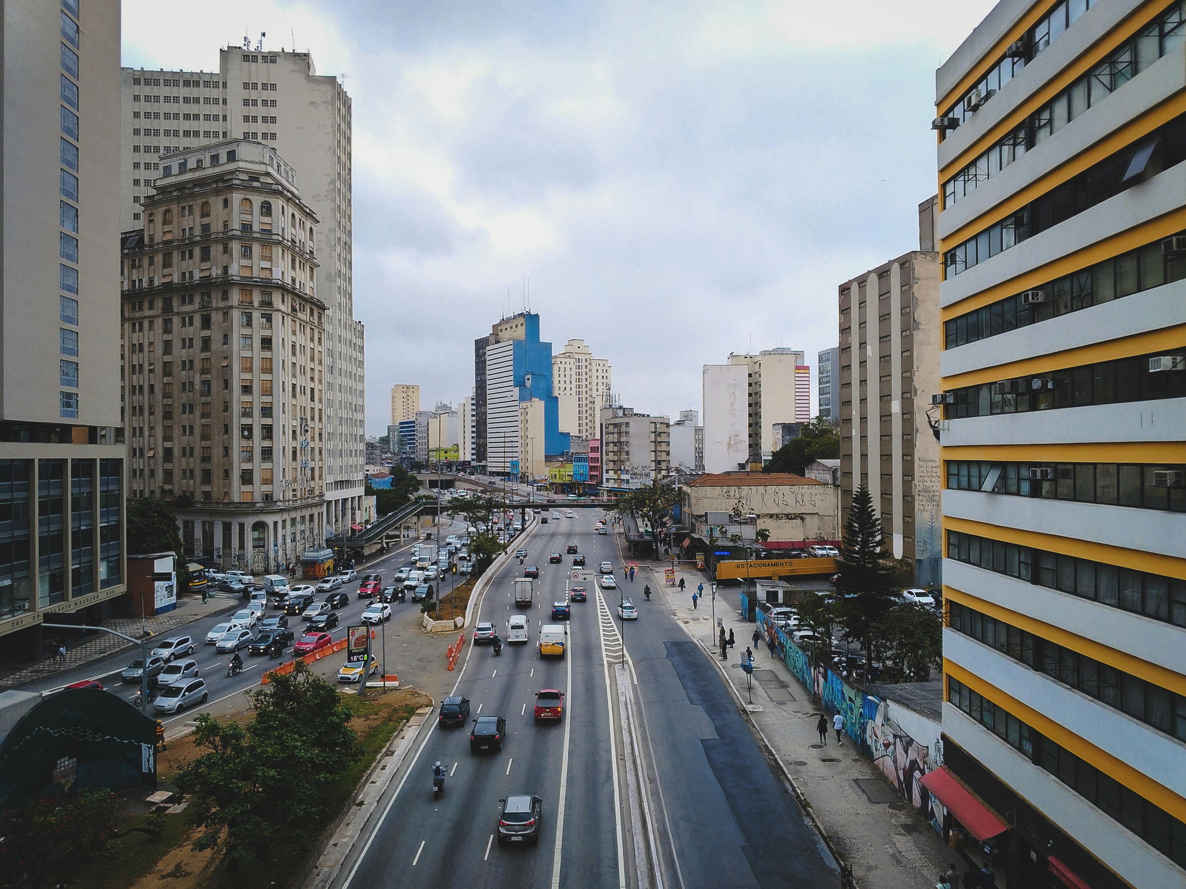 View of highway and cars, trucks in the city Sao Paolo surrounded by large buildings