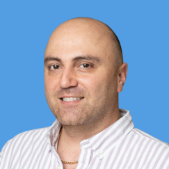 Saman headshot in front of blue background