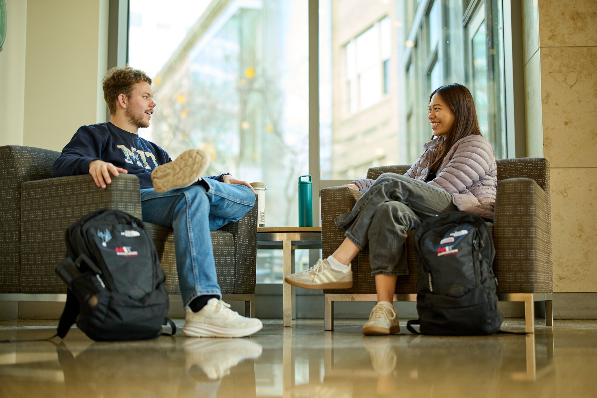 Two students sitting and talking together
