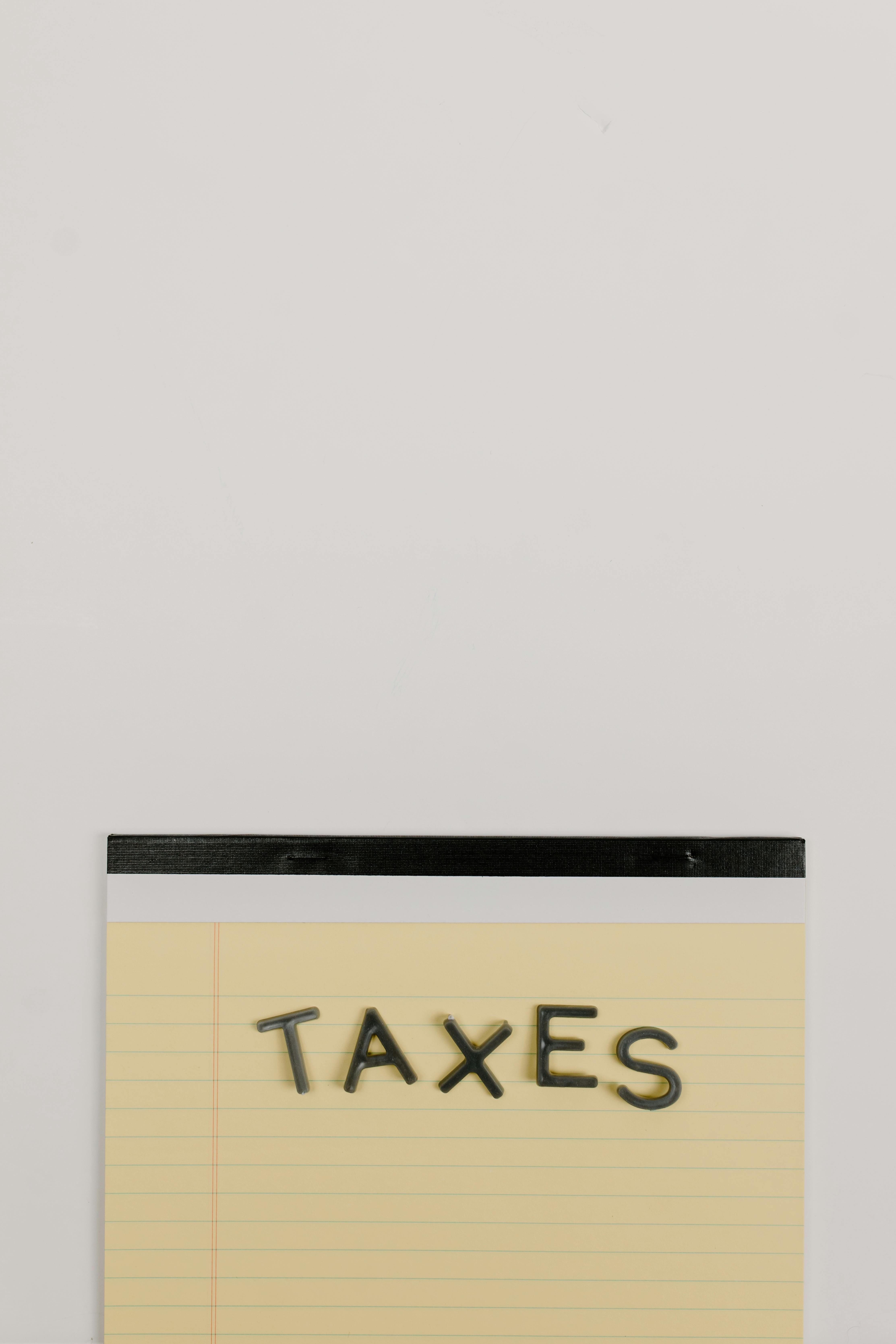 Yellow Notepad with the Word Taxes
