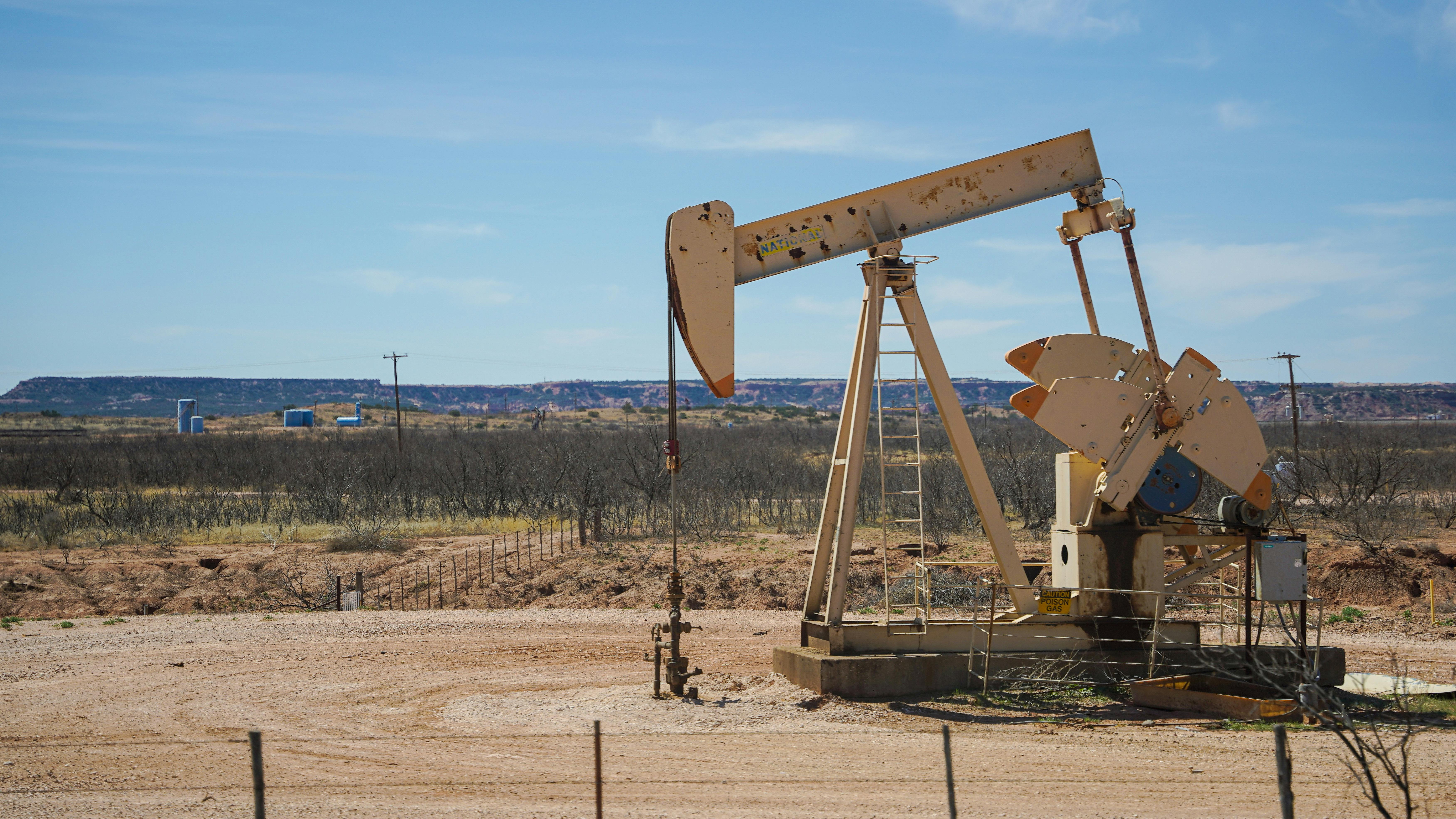 A Gray Steel Pumpjack Under Blue Sky