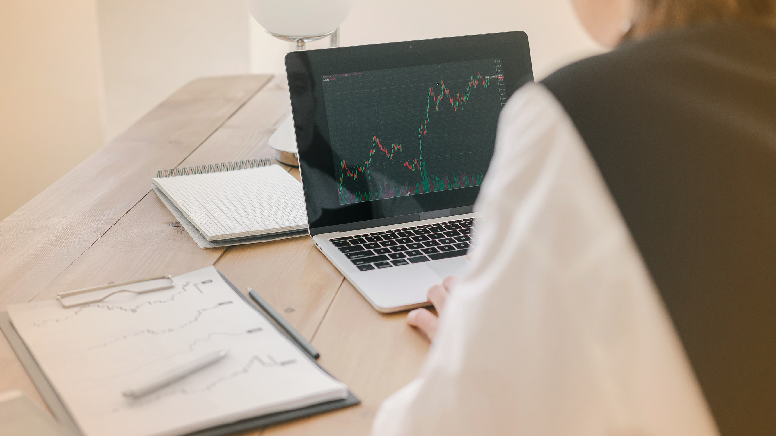 Person viewing stock trends on a laptop