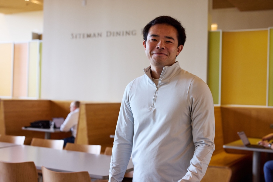 student stands in Sloan cafe