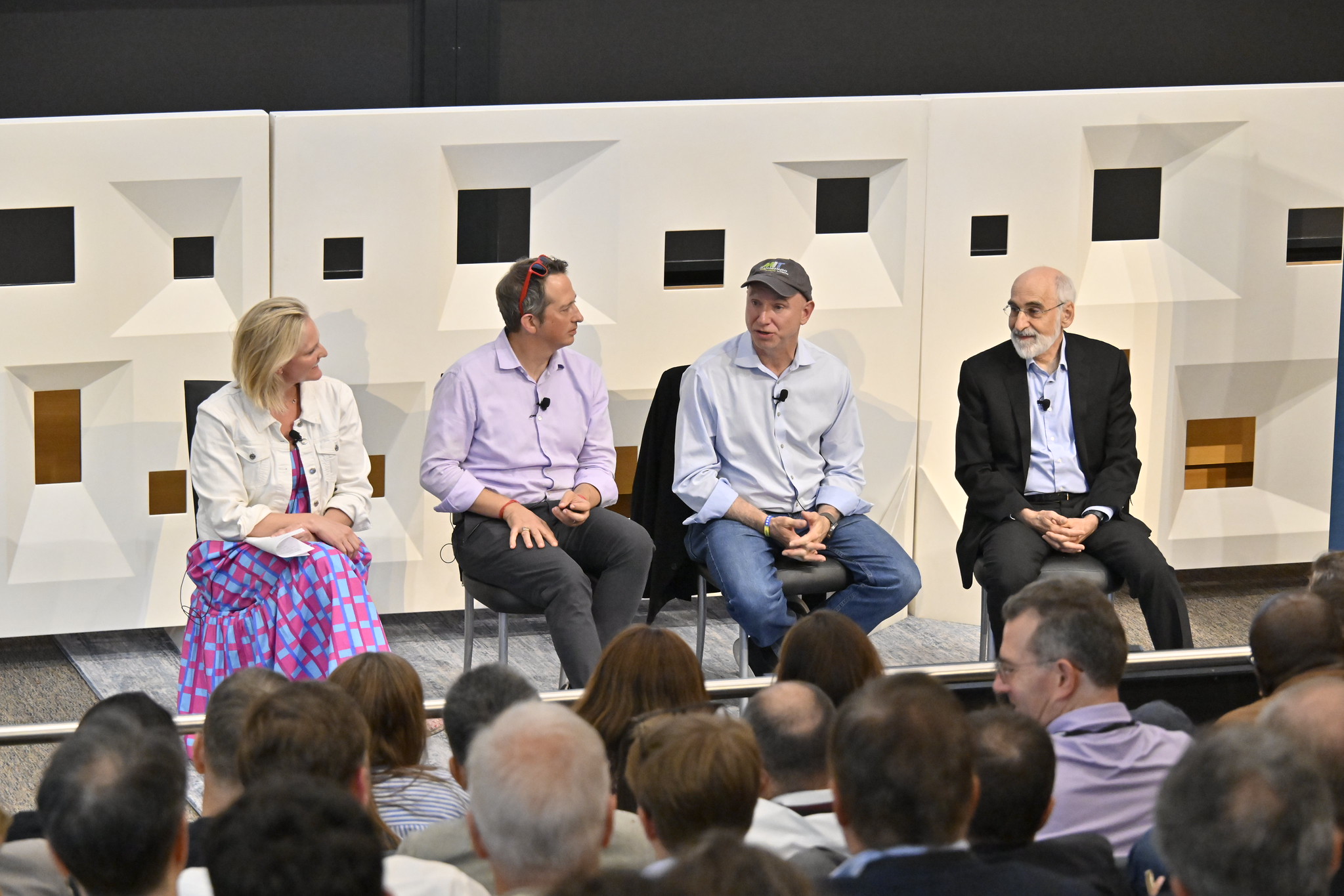 A panel speaks to an audience