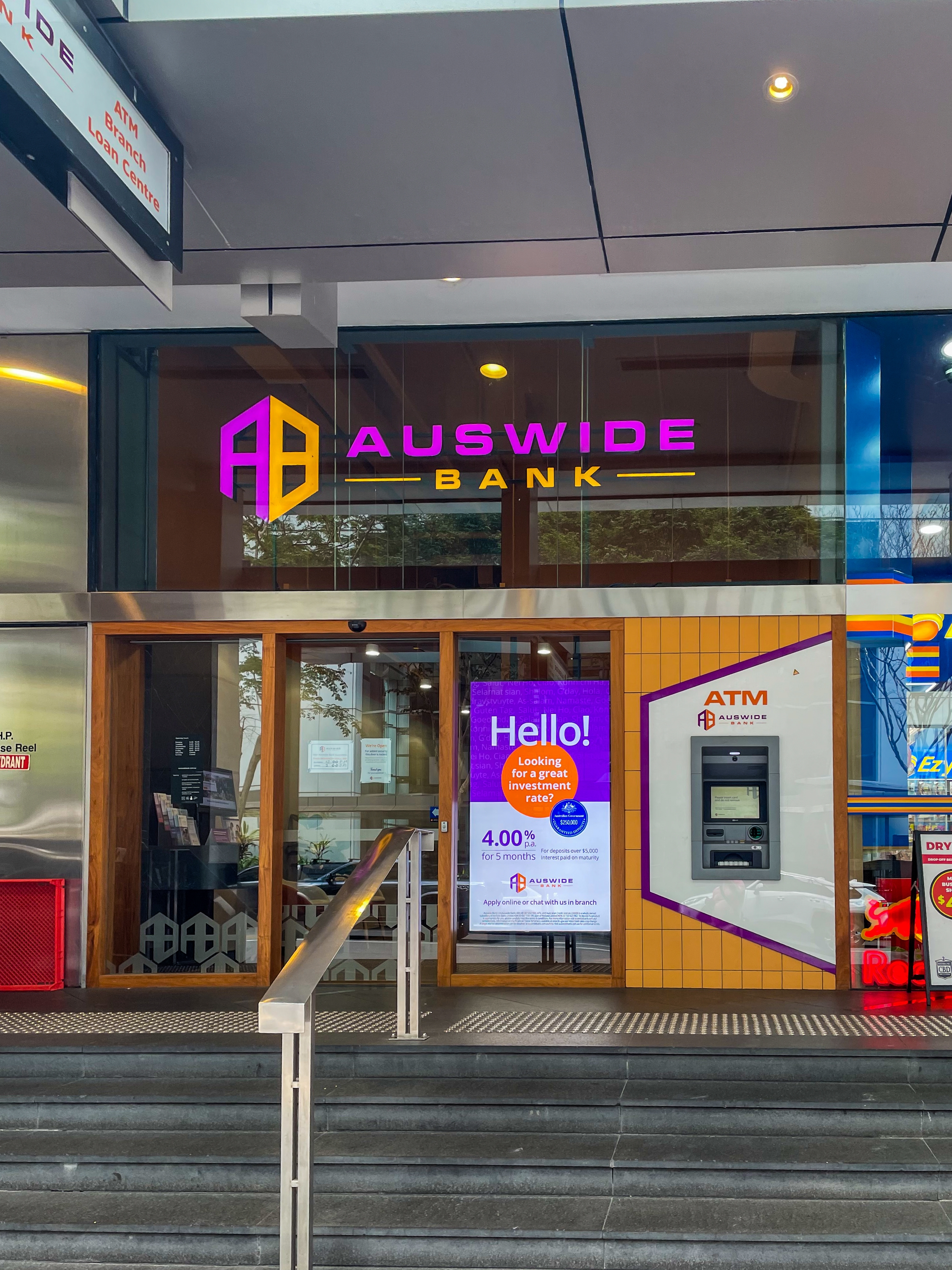 Steps leading up to Auswide Bank which has a modern, colorful entryway 