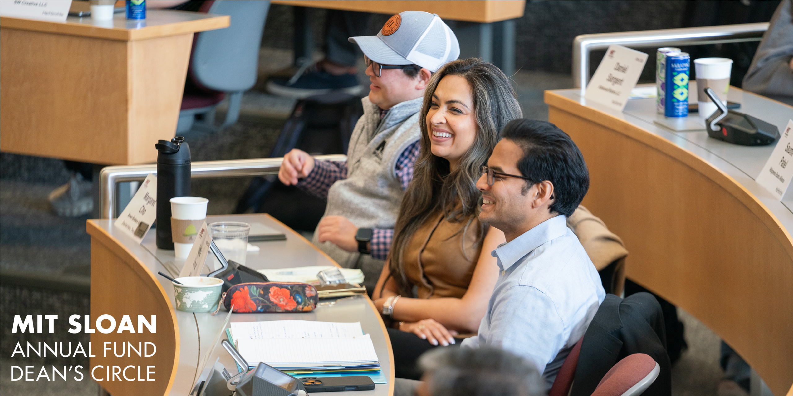 Three students working in MIT Sloan classroom