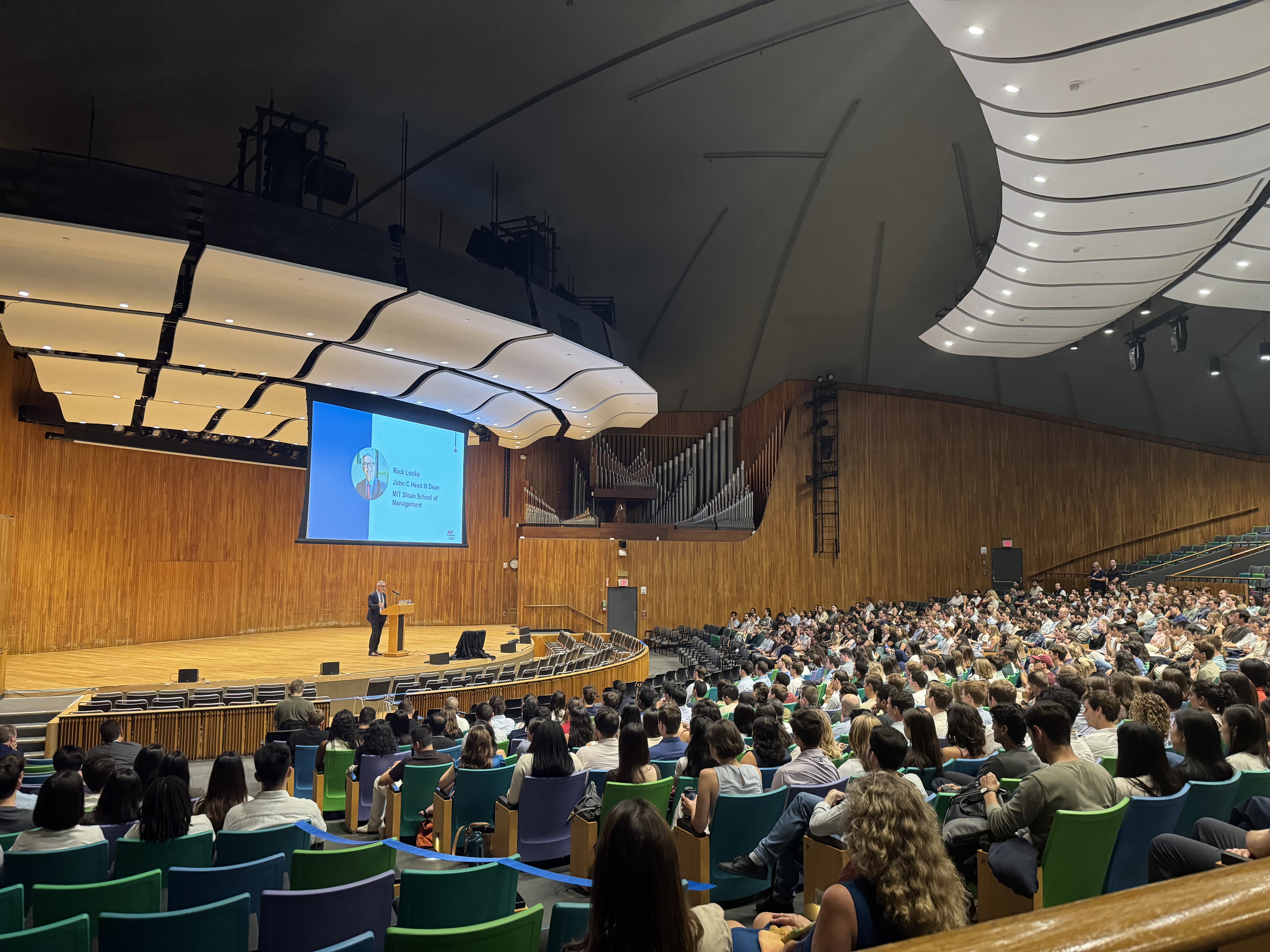 Taken from the back of an auditorium full of students, Dean Rick Locke speaks at a podium