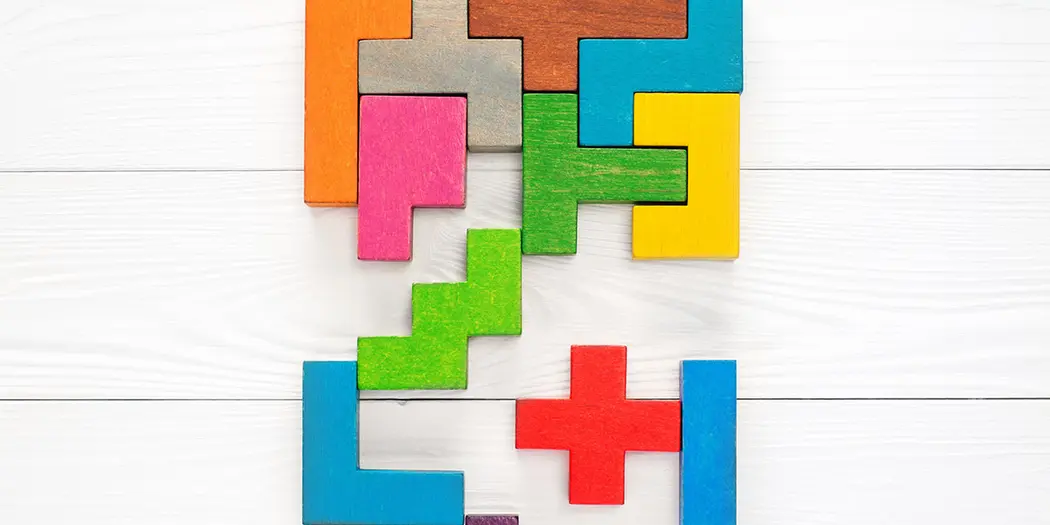An image of a group of physical Tetris-like blocks being arranged to represent a strategy.