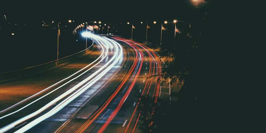 A timelapse photograph of a highway at night.