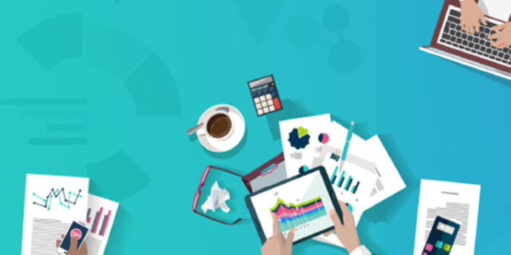 Hands working with laptops, documents and tablets on a blue background showing charts.