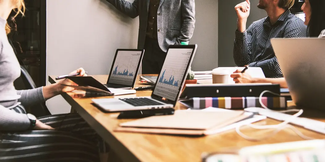 People discussing graphs in meeting