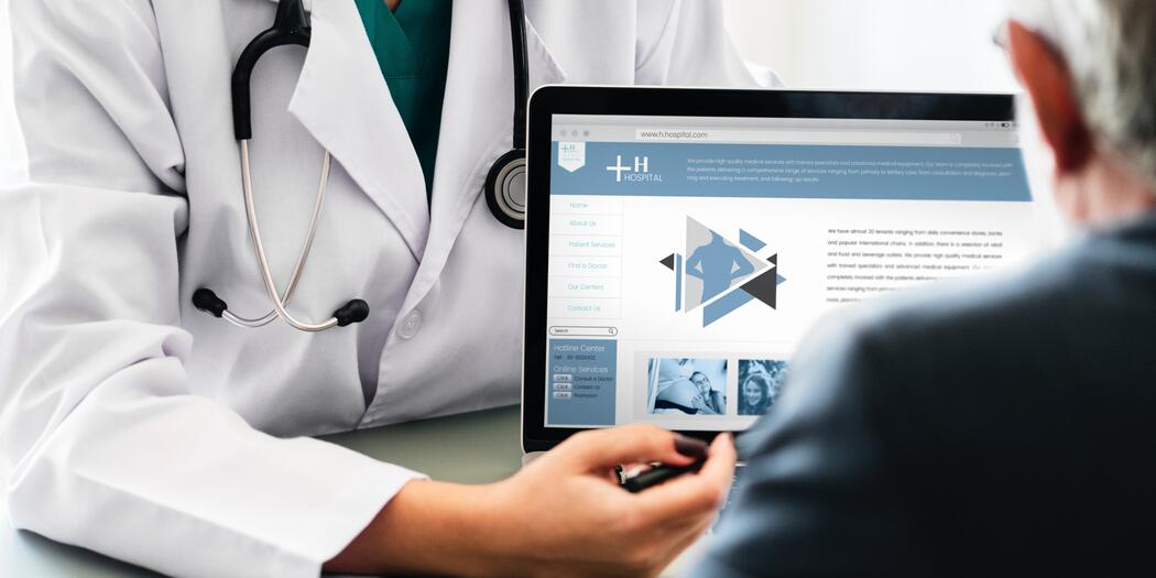 Doctor showing person a laptop screen