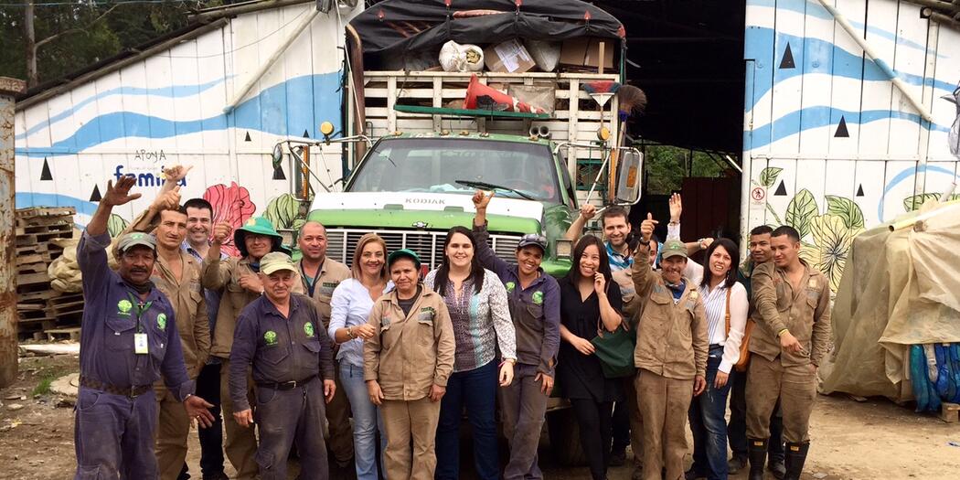Students and workers standing in a group in front of truck