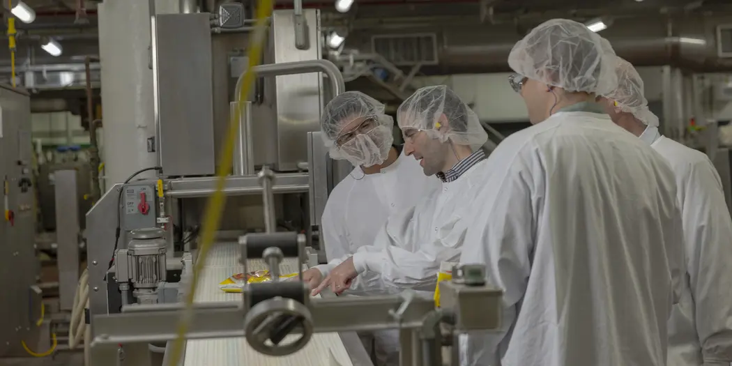 Ops-Lab team looking over conveyor belt at Gorton's Gloucester warehouse