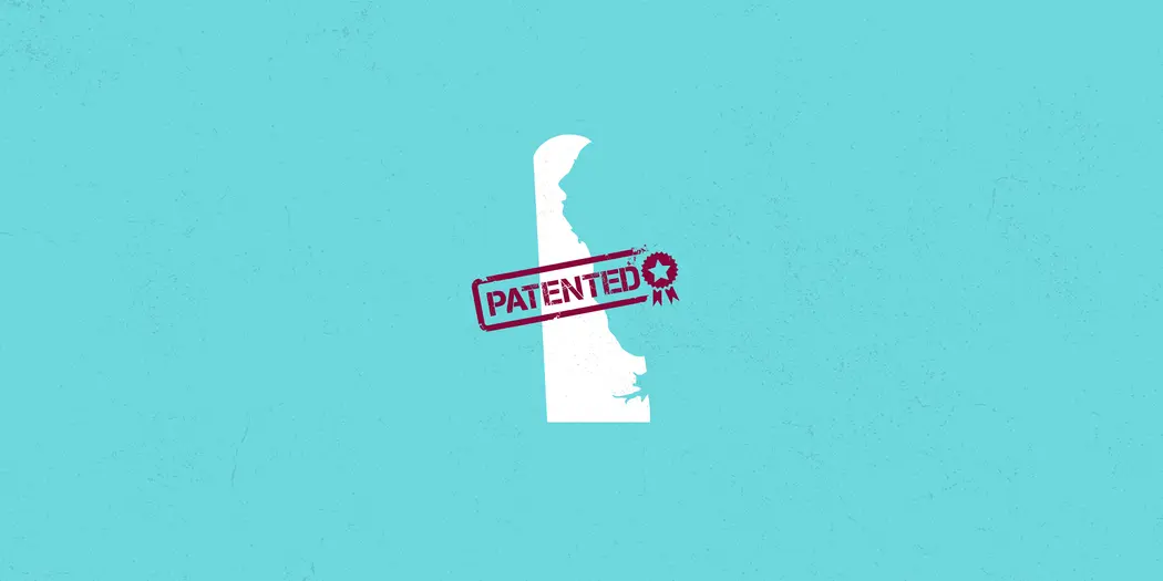 outline of the state of delaware with a patent stamp