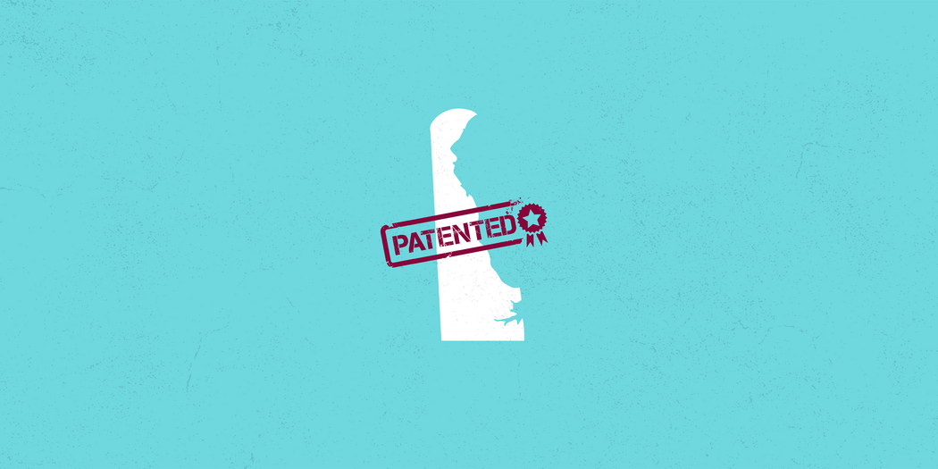 outline of the state of delaware with a patent stamp