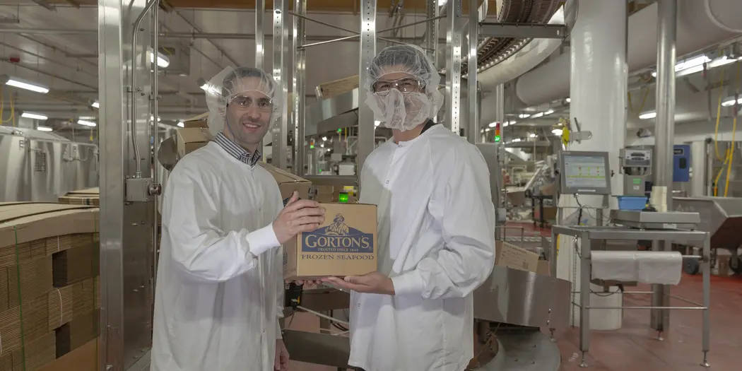 Ops-Lab students holding a box of frozen seafood at Gorton's of Gloucester.