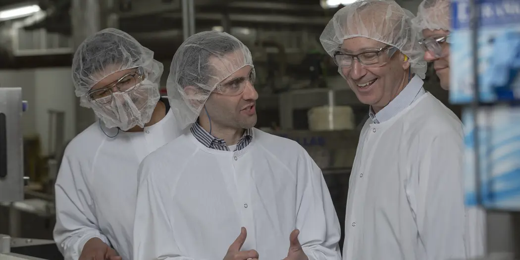 Two Ops-Lab students talking with host in Gorton's of Gloucester factory