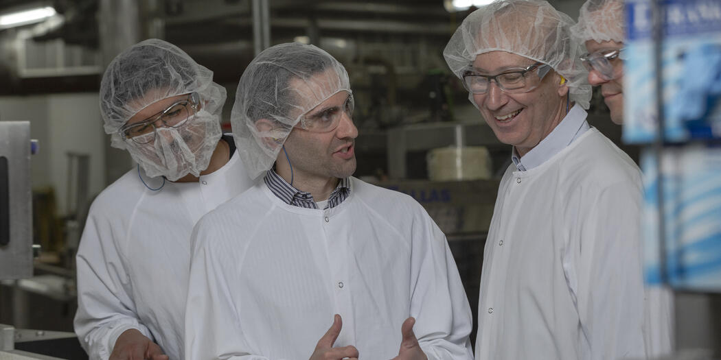 Two Ops-Lab students talking with host in Gorton's of Gloucester factory