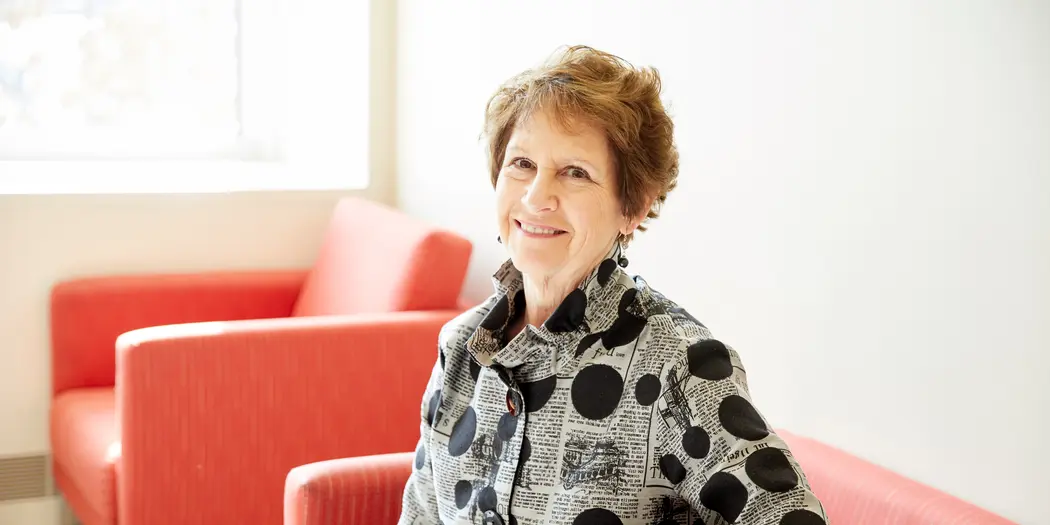 Nancy Van Milligen, CEO and president of the Community Foundation of Greater Dubuque, sitting in red chair