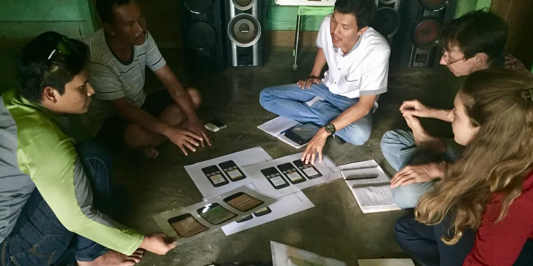 Illustrating and discussing market design ideas with market participants in rural Indonesia.