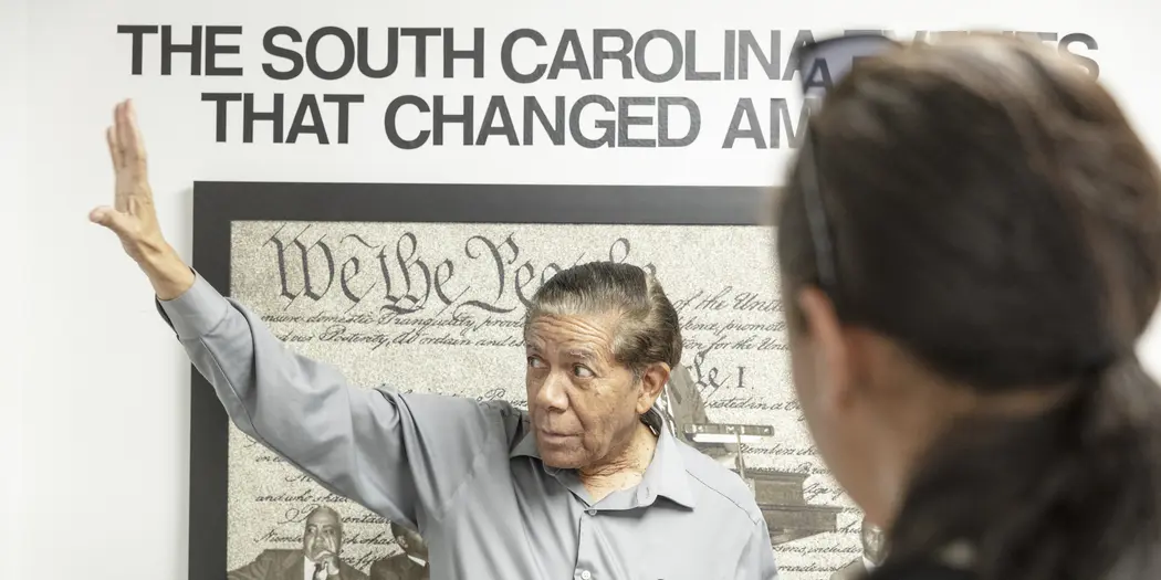 Cecil Williams showing an exhibit in his civil rights museum to USA Lab students