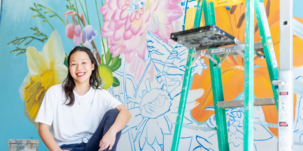 Linda Cheung in front of one of her murals.