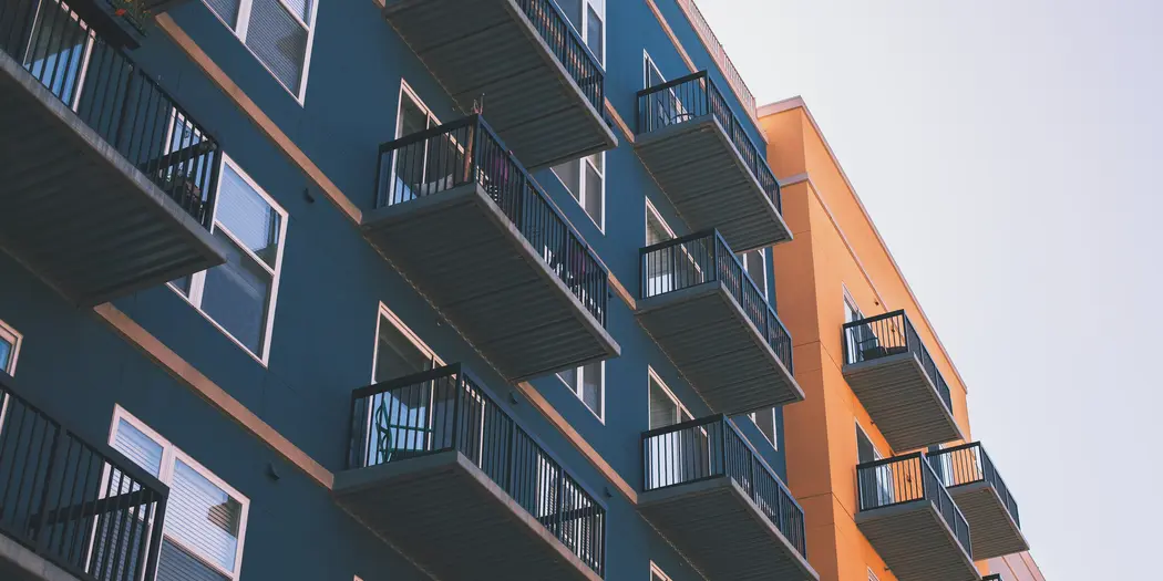 Dark green and orange apartment building with balconies