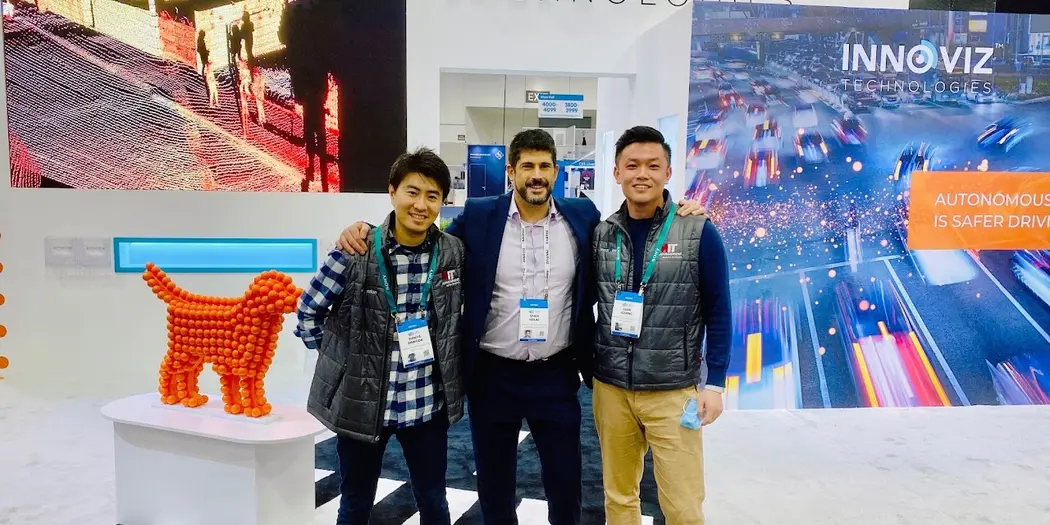 Shinya Shinoda, Omer Keilaf, and Jizheng Luan standing in front of Innoviz Technologies display